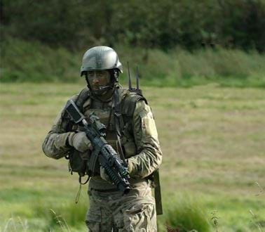 A soldier in camouflage with facepaint