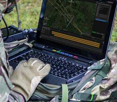 A soldier using the VIPER software on a ruggedised laptop