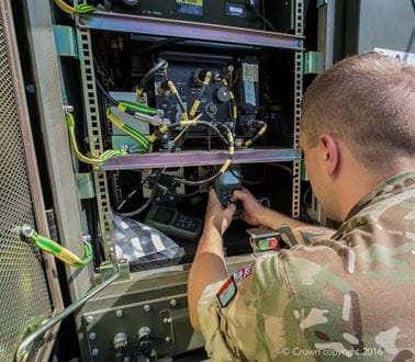 A soldier working on an electronic system