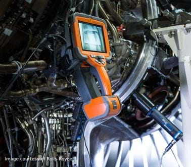 A borescope inspecting a turbine engine