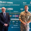 Paul MacGregor, Managing Director, and Colonel Ash pose with ZODIAC framework diagram