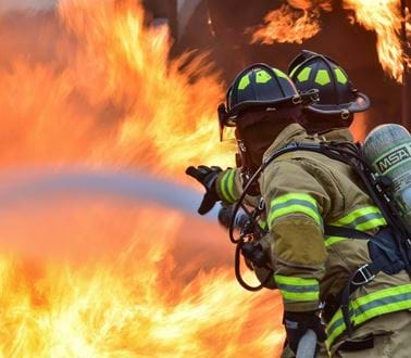 Firefighters hosing down a fire