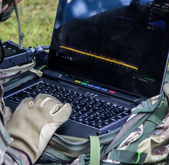 A soldier using the VIPER software on a ruggedised laptop