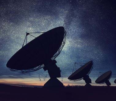 Satellite dishes under the stars