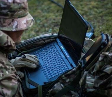 A soldier using the VIPER software on a ruggedised laptop