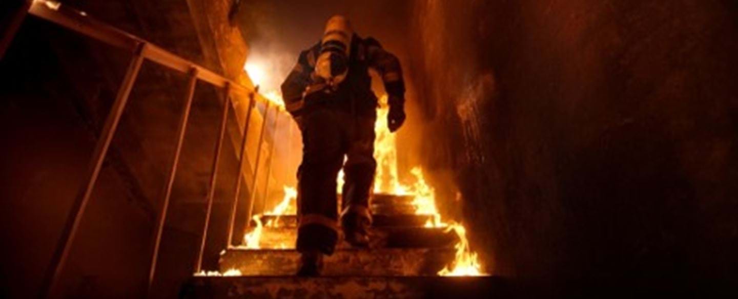 A fireman entering a burning building