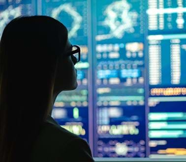 A female engineer analyses data on a screen