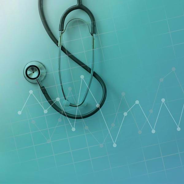 a stethoscope and a line graph on a turquoise background